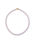 A beaded necklace made of small white beads separated by tiny pink accents, with a gold clasp, shown on a plain white background.